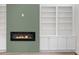 Close-up of the living room's fireplace, built-in shelving, and minimalist decor at 2015 Saddlebrook Dr, Archer Lodge, NC 27527