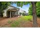 Wide backyard view with a screened-in porch and lush landscaping at 2018 Remington Oaks Cir, Cary, NC 27519
