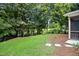Lush backyard featuring green grass, mature trees, and stepping stones at 2018 Remington Oaks Cir, Cary, NC 27519