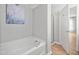 Bright bathroom features a modern tub and separate glass-door shower at 2018 Remington Oaks Cir, Cary, NC 27519