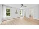 Large bedroom with wood-look floors, ceiling fan, ensuite bath, and lots of natural light at 2018 Remington Oaks Cir, Cary, NC 27519