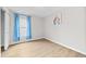 Bedroom with light blue curtains, light walls, and wood-look floors at 2018 Remington Oaks Cir, Cary, NC 27519