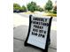 Amberly Farmstand sign showing the date and time of the farmstand in front of landscaped homes at 2018 Remington Oaks Cir, Cary, NC 27519
