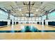 Spacious gymnasium with basketball hoops and a shiny hardwood floor at 2018 Remington Oaks Cir, Cary, NC 27519