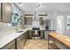 Bright kitchen with stainless appliances, quartz countertops and a central island at 2018 Remington Oaks Cir, Cary, NC 27519