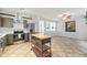Bright kitchen boasts stainless steel appliances, ample gray cabinetry, and a functional mobile island at 2018 Remington Oaks Cir, Cary, NC 27519