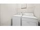 Convenient laundry room with washer, dryer, and shelving for storage at 2018 Remington Oaks Cir, Cary, NC 27519
