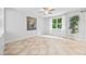 Bright living area with large windows, neutral walls, and tile flooring at 2018 Remington Oaks Cir, Cary, NC 27519