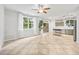 Bright living space with large windows, neutral walls, and tile flooring throughout at 2018 Remington Oaks Cir, Cary, NC 27519