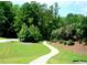 Scenic paved pathway winding through a well-maintained green space at 2018 Remington Oaks Cir, Cary, NC 27519