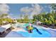 Community pool area with waterslides, pools, and lounge chairs at 2018 Remington Oaks Cir, Cary, NC 27519