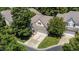 An aerial view of a charming home featuring neutral siding, a two-car garage, and lush landscaping at 206 Lake Brandt Dr, Cary, NC 27519