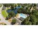 An aerial view of a community with a pool, lake, clubhouse, parking, and mature trees providing a serene and luxurious atmosphere at 206 Lake Brandt Dr, Cary, NC 27519