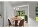 Charming dining area featuring a round table, four chairs, and a sliding door to the backyard at 206 Lake Brandt Dr, Cary, NC 27519