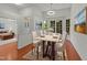 Dining room featuring hardwood floors, a bay window, and a modern light fixture at 206 Lake Brandt Dr, Cary, NC 27519