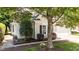 Charming home featuring an ADT security sign, lush landscaping, and dark window shutters at 206 Lake Brandt Dr, Cary, NC 27519