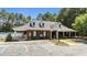 Community clubhouse exterior featuring a red brick facade, ample parking, and manicured landscaping at 206 Lake Brandt Dr, Cary, NC 27519