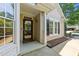 Inviting front porch with a decorative wreath, a full glass storm door, and exterior window shutters at 206 Lake Brandt Dr, Cary, NC 27519