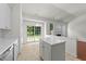 Bright kitchen features white cabinets and a view of the living room at 206 Lake Brandt Dr, Cary, NC 27519