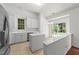 Bright kitchen features white cabinets, island, stainless appliances, and sliding doors to the backyard at 206 Lake Brandt Dr, Cary, NC 27519