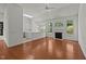 Open-layout living room with fireplace and kitchen in the background at 206 Lake Brandt Dr, Cary, NC 27519