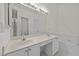 Well-lit bathroom features a dual sink vanity, large mirror, soaking tub, and doorway leading to a separate toilet room at 206 Lake Brandt Dr, Cary, NC 27519