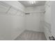 Organized walk-in closet featuring white wire shelving for efficient storage of clothing and personal items at 206 Lake Brandt Dr, Cary, NC 27519