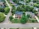 Aerial view of a beautiful brick home with a landscaped front yard, surrounded by lush greenery and neighborhood streets at 2224 Narrawood St, Raleigh, NC 27614