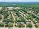 Expansive aerial view of a residential community with mature trees, well-manicured lawns, and a glimpse of a lake in the distance at 2224 Narrawood St, Raleigh, NC 27614