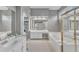 Large bathroom with tile flooring, double sinks, walk-in shower and relaxing jacuzzi tub at 2224 Narrawood St, Raleigh, NC 27614