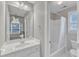 Clean bathroom with a tub/shower combo, white cabinets and a large mirror above the vanity at 2224 Narrawood St, Raleigh, NC 27614