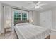 Bedroom featuring a ceiling fan, window with curtains and two bedside tables with lamps at 2224 Narrawood St, Raleigh, NC 27614