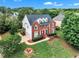 Exterior elevation of a stunning two-story brick home with a well-manicured lawn and mature landscaping at 2224 Narrawood St, Raleigh, NC 27614
