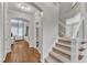 Hallway featuring hardwood floors, a staircase, and views of other living spaces at 2224 Narrawood St, Raleigh, NC 27614