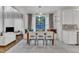 Bright eat-in kitchen with a window bench, wooden table, and open layout leading to the living room area at 2224 Narrawood St, Raleigh, NC 27614