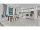 Bright eat-in kitchen with white cabinets, subway tile backsplash, stainless steel appliances, and breakfast bar seating at 2224 Narrawood St, Raleigh, NC 27614