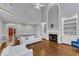 Inviting living room featuring a cozy fireplace, built-in cabinets, and plush white furniture with staircase visible at 2224 Narrawood St, Raleigh, NC 27614