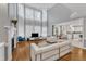 Bright living room with tall windows, fireplace, hardwood flooring, and white couches adjacent to open kitchen at 2224 Narrawood St, Raleigh, NC 27614