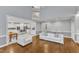 Open concept living room with hardwood floors and access to the kitchen with a staircase to the second floor at 2224 Narrawood St, Raleigh, NC 27614