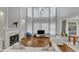 Open and airy living room boasts large windows, fireplace, hardwood floors, and bright white decor at 2224 Narrawood St, Raleigh, NC 27614