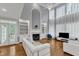 Spacious living room with a fireplace, built-in shelving, and plenty of natural light at 2224 Narrawood St, Raleigh, NC 27614