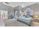 This primary bedroom offers a large layout, a cozy chair, and windows with wooded views at 2224 Narrawood St, Raleigh, NC 27614