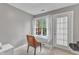 Bright home office features a white desk, comfortable chair, and a window for natural light and fresh air at 2224 Narrawood St, Raleigh, NC 27614