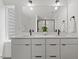Modern bathroom featuring a double vanity, large mirror, and sleek fixtures at 2225 Millbank Village Ct # 101, Raleigh, NC 27610