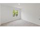 Neutral bedroom with a window, light gray carpet and white walls at 2225 Millbank Village Ct # 101, Raleigh, NC 27610