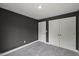 Bedroom with dark gray walls, light carpet, and a closet with bi-fold doors at 2225 Millbank Village Ct # 101, Raleigh, NC 27610