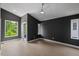 Bedroom featuring an accent wall, ceiling fan, and two large windows at 2225 Millbank Village Ct # 101, Raleigh, NC 27610