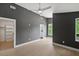 Bright bedroom featuring a ceiling fan, grey walls, and a walk-in closet at 2225 Millbank Village Ct # 101, Raleigh, NC 27610