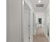 Bright hallway with hardwood floors and multiple doors leading to various rooms at 2225 Millbank Village Ct # 101, Raleigh, NC 27610