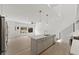 Bright, open kitchen with stainless steel appliances, island, and hardwood floors at 2225 Millbank Village Ct # 101, Raleigh, NC 27610